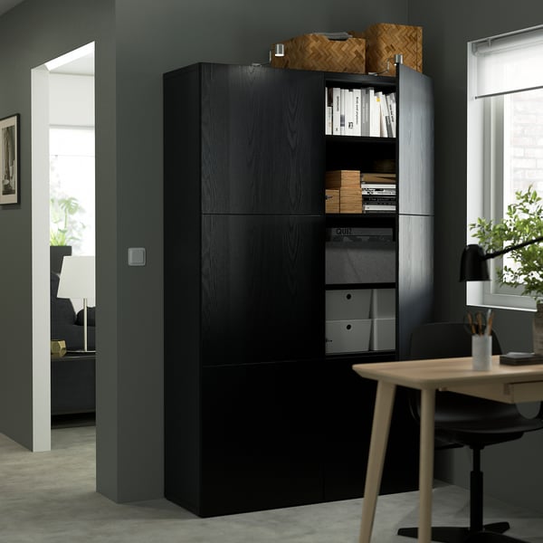 Modern workspace with wood storage, office chair, and plant.
