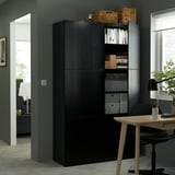 Modern workspace with wood storage, office chair, and plant.