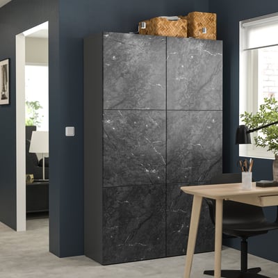 Modern dark grey BESTÅ storage unit with marble effect. Rectangular, four doors, surrounded by office decor.