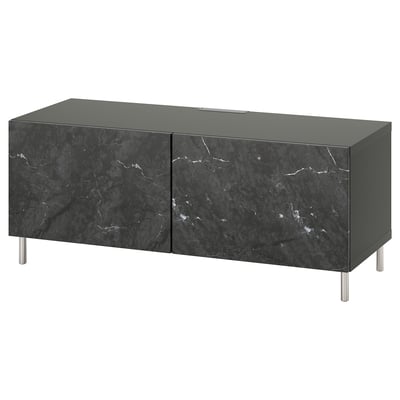 A modern black marble tv stand with two cabinet doors and metal legs. Its part of the ikea BESTÅ series, offering sleek design and practical storage.