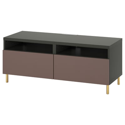 A modern BESTÅ tv stand in black with purple drawers and gold legs. It has storage compartments and cable outlets.