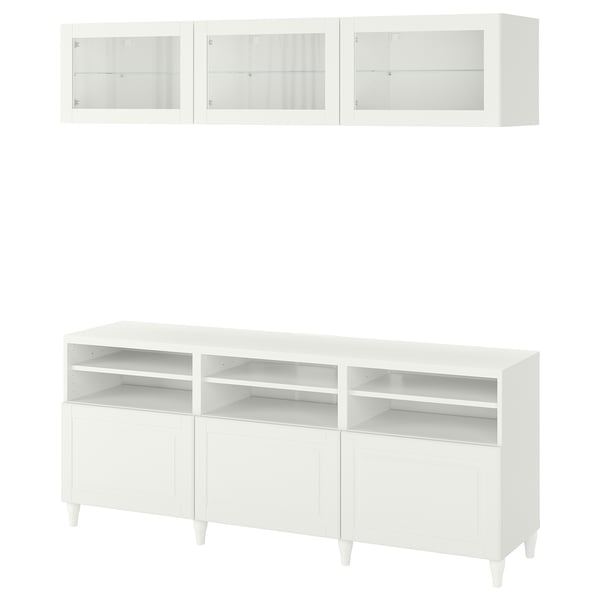White BESTÅ tv unit with adjustable shelves, glass doors, wall cabinets.