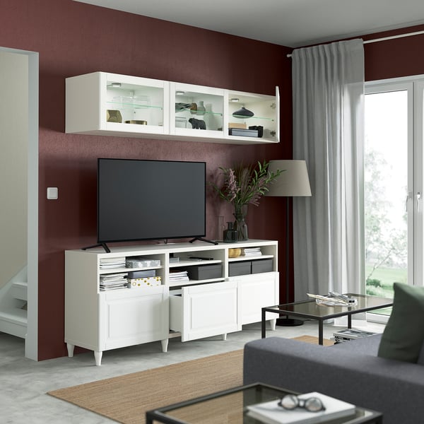 Modern living room with BESTÅ tv unit, flat-screen tv, and grey sofa. Decorative items and storage solutions visible.