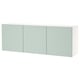 A wall-mounted BESTÅ cabinet in light green with three doors offering storage. Its sleek, minimalist design soft-close hinges.