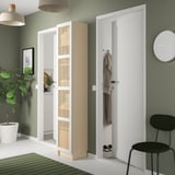 Modern hallway with green walls; includes white BILLY bookcase with bamboo doors, black chair, white pendant lights, and a green plant.