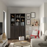 Modern living room with BILLY bookcase, kids chair, and drawings on walls.