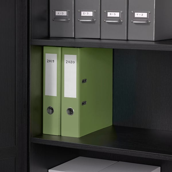 Shelf unit with green binders labeled 2019 and 2020 for document storage and organization.