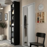 Modern living room with BILLY bookcase, closet, chair, plant.