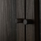 Dark wooden door with two round, black cylindrical door handles, centered and evenly spaced.