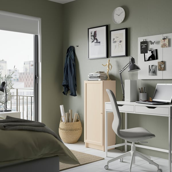 Cozy bedroom with BILLY bookcase, desk, laptop, balcony & jacket. Or bedroom: BILLY bookcase, desk with laptop, balcony, green walls.
