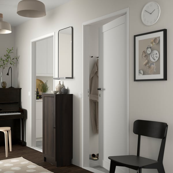 Dark brown BILLY bookcase in modern room with black chair.
