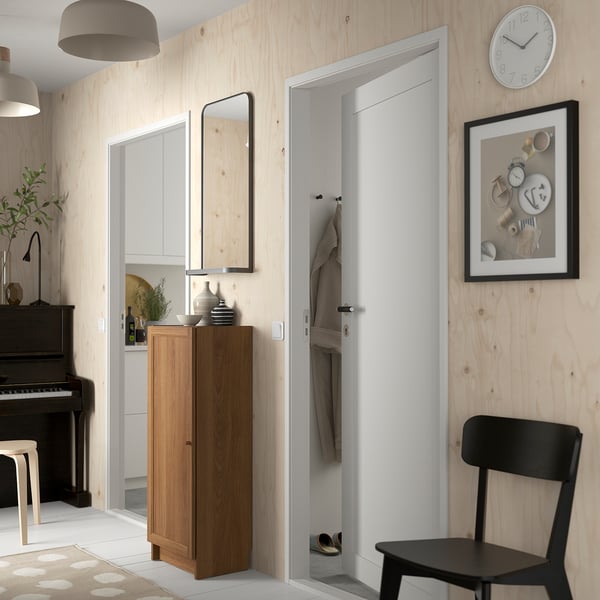 Entryway with BILLY bookcase, chair, closet, piano, clock, and art.