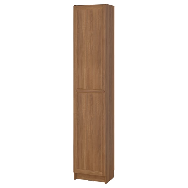 A BILLY tall bookcase in oak colour, made of particleboard and fiberboard, standing upright with two doors.