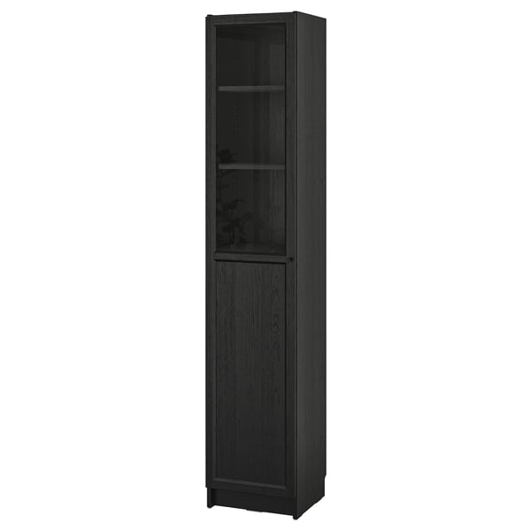 A black BILLY bookcase. It a modern design with a wooden texture. The tall, rectangular shape includes a glass door for dust-free storage.