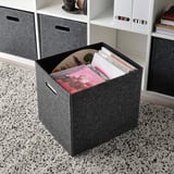 Gray storage box with handles, open showing magazines, fits kallax shelves.