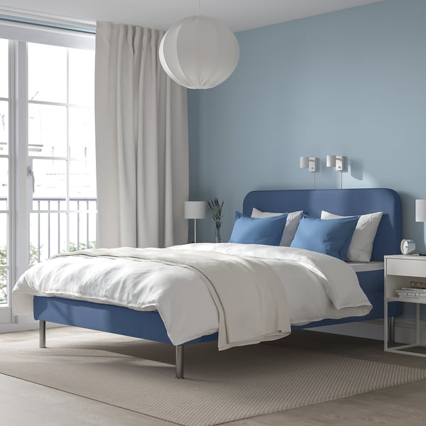 Modern blue BLÅFJÄLLET bed, clean design, metal frame, large windows, cosy.
