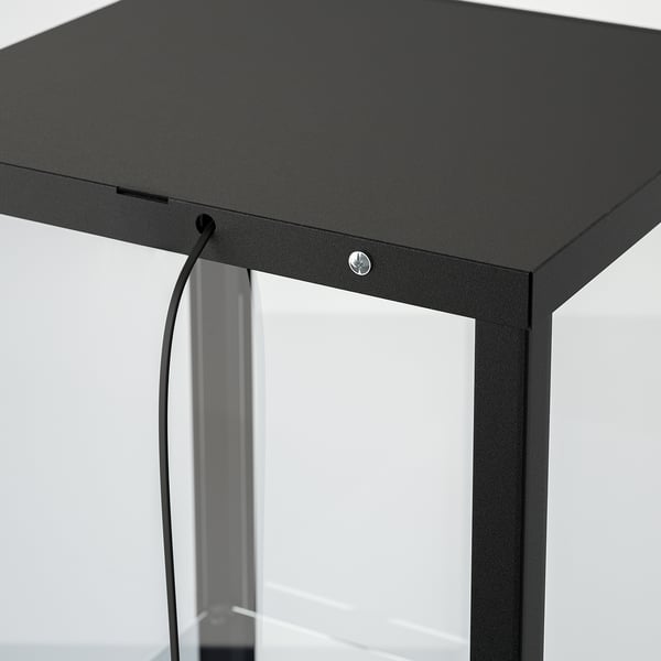 Black glass-door cabinet with integrated lighting cable management, showing sleek design and modern style.