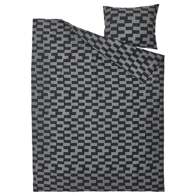 Black and gray geometric patterned bedding set, folded with pillow.