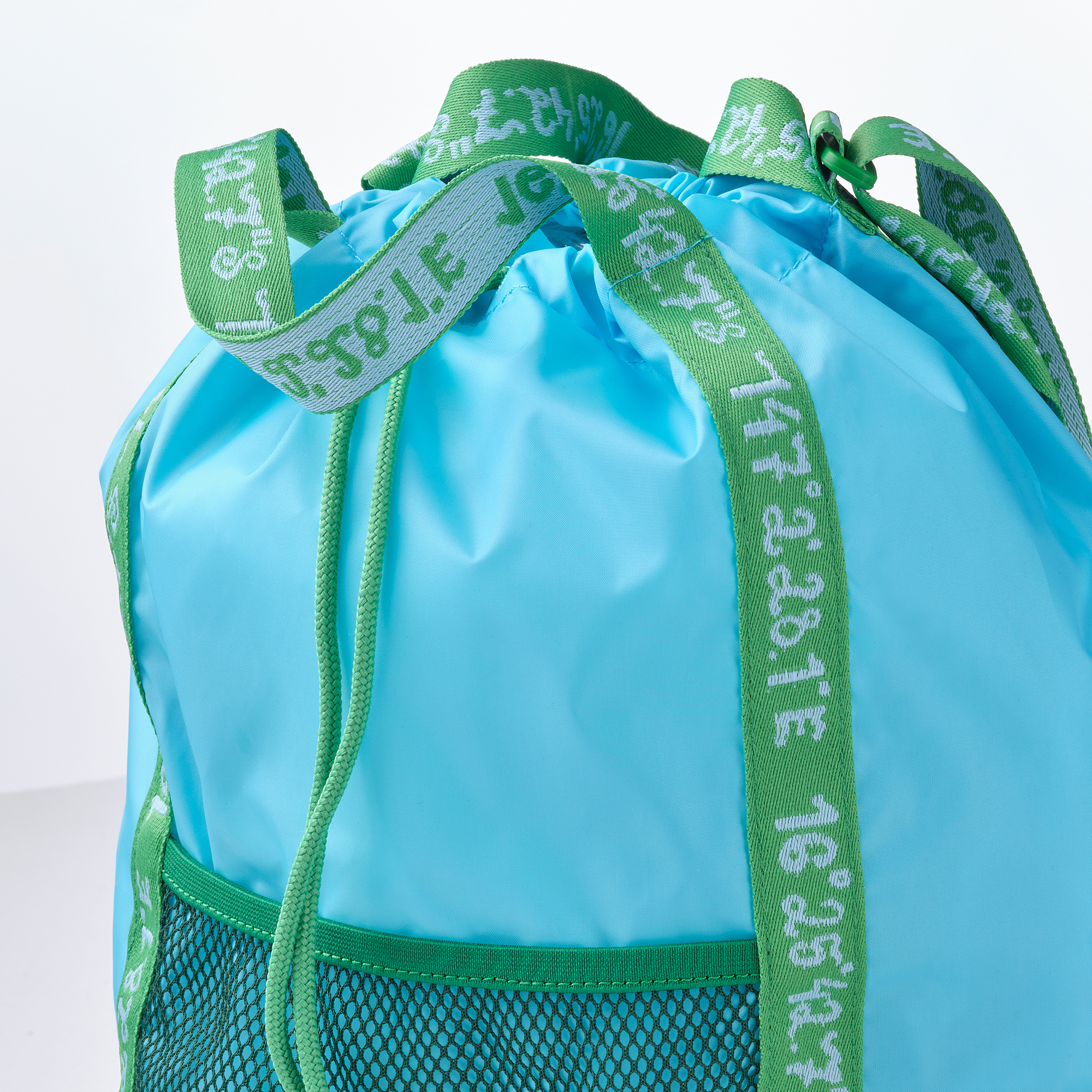 Turquoise drawstring bag with green trim, strong mesh pocket, neatly stitched for durability.