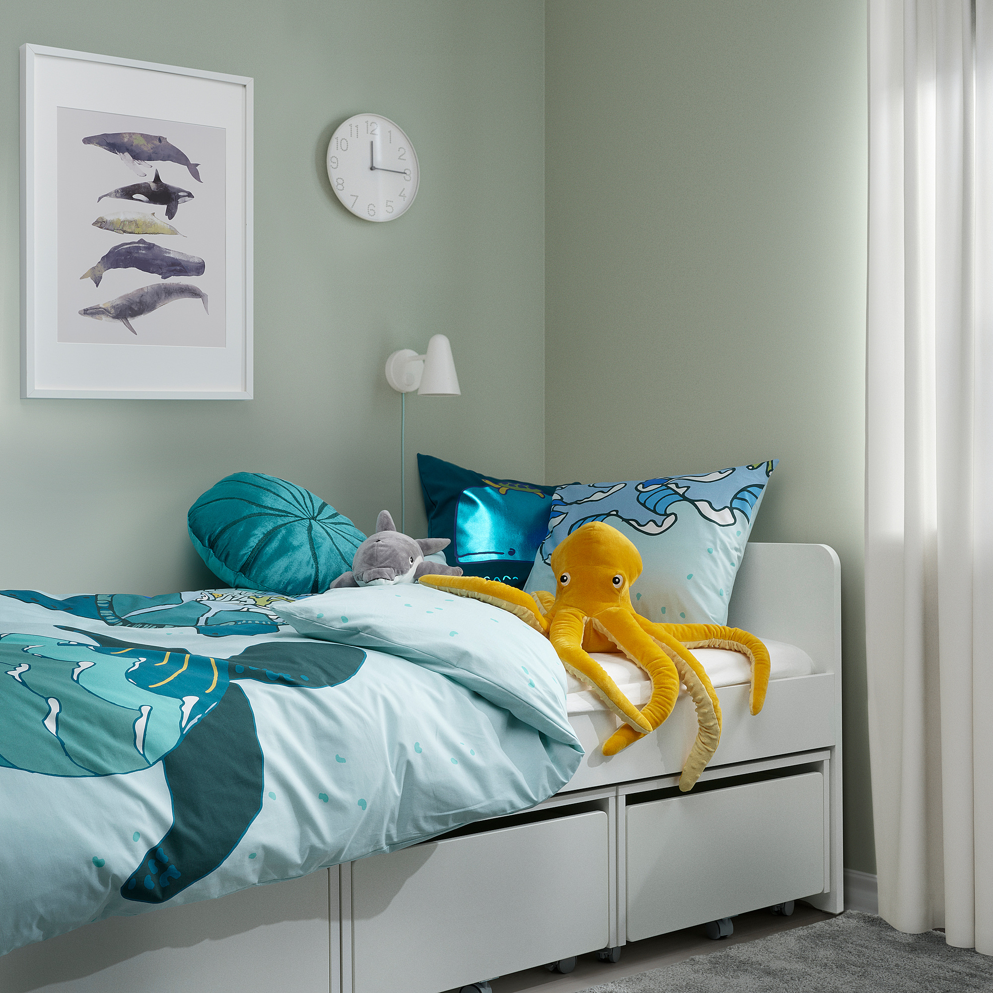 Turquoise BLÅVINGAD bedding with turtles, yellow octopus toy, whale pic, clock.