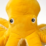 Soft, bright yellow octopus plush toy with black eyes, perfect for cuddling. Recycled materials ensure durability and safety.