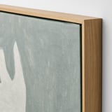 Close-up of canvas art print with natural oak frame, showcasing high-quality material and craftsmanship.