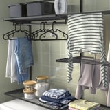 Laundry organizer: clothes hangers, shelves with detergent, clean clothes drying.
