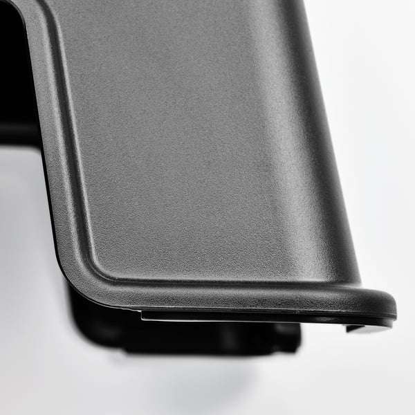 Close-up of a black plastic step stool, showcasing its smooth, sturdy surface and anti-slip edge.