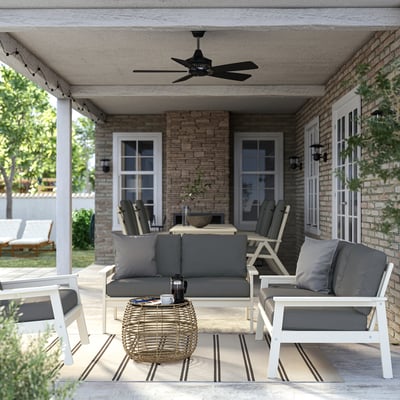 Modern patio set: white 2-seat sofa & ceiling fan on brick porch, comfortably sized.