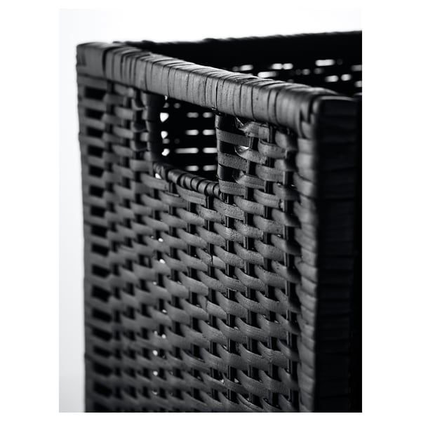 Black and white handwoven rattan basket. Shows intricate weave and sturdy frame.