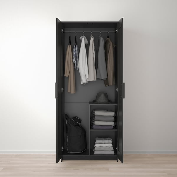 Black wardrobe with clothes rail, shelf, and backpack storage. Folds and hangs garments neatly.