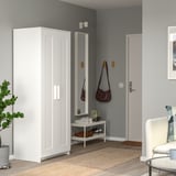 White wardrobe stand beside door, tall for long garments, mirrored, modern.