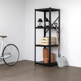 Black BROR shelf holds two lanterns, boxes, and clay pots. Leaned against it is a metal tool. A white bike rests nearby. Minimalist room.