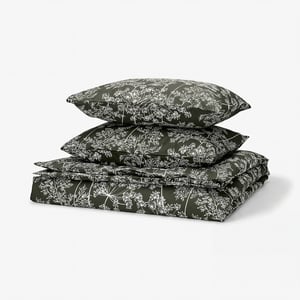 Dark green duvet set with white floral print, featuring two pillows and a fitted sheet, crafted from a smooth cotton/lyocell blend.