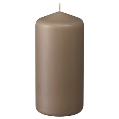 A brown DAGLIGEN pillar candle, made of paraffin and plant wax, with a cotton wick, standing upright with a smooth, cylindrical design.