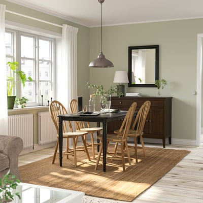 Cozy dining room with DANDERYD table, wooden chairs, and large windows, bright and inviting.