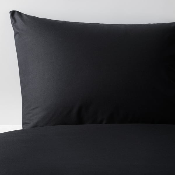 Smooth, black cotton pillowcase on white background, showcasing soft, high-quality fabric.