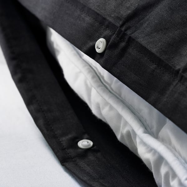 Close-up of duvet covers press-stud closure, showcasing its functional design.