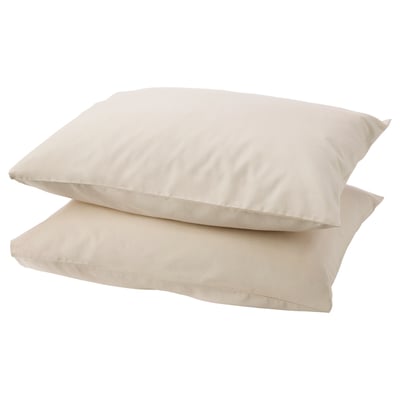 Two light beige DVALA cotton pillowcases, rectangular, plain, stacked neatly.