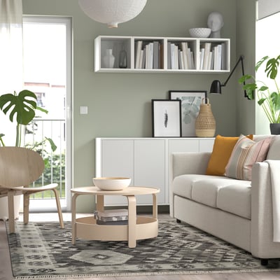 Living room with grey DVÄRGVETEN rug, plants, sofa, coffee table.