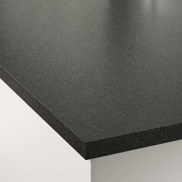 A close-up of a sleek, dark-colored kitchen worktop with a smooth, polished surface. It rounded edges and looks modern and durable.