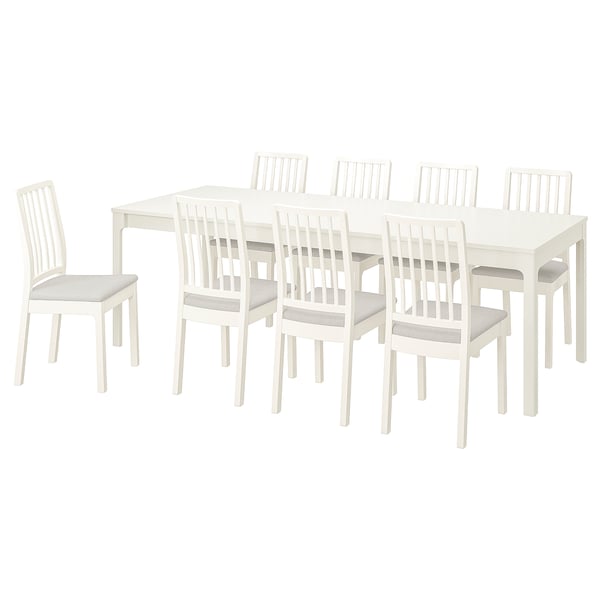 White EKEDALEN extendable dining table with 6 matching chairs and light gray cushions.