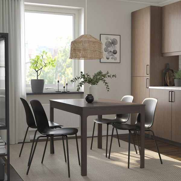 EKEDALEN table set with extendable dark brown table, 4 black chairs, beige pendant lamp, near large window.