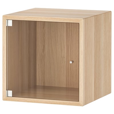 Light oak-colored, square storage cabinet with glass door.