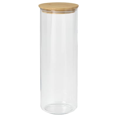A clear glass jar named EKLATANT with a wooden lid. It is cylindrical, suitable for storing food, and has a simple, elegant design.
