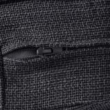 Close-up view of fine-textured, dark fabric with robust zipper detail. Highlights quality and durability.