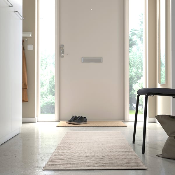 Rug in doorway, anti-slip mat underneath, provides comfort and prevents slipping.
