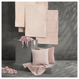 Pink handwoven rugs and cushions on grey blocks. Natural cotton, unique design.