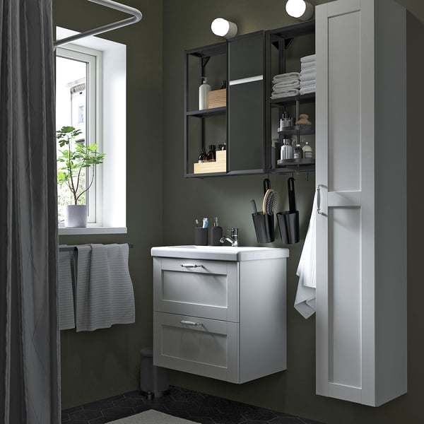 Small bathroom with ENHET white storage, sink, mirror with lights, and tall cabinet.