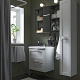 Small bathroom with ENHET white storage, sink, mirror with lights, and tall cabinet.